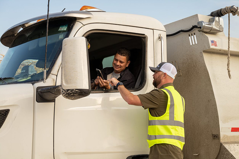 Photo of Brian Jones talking to truck driver